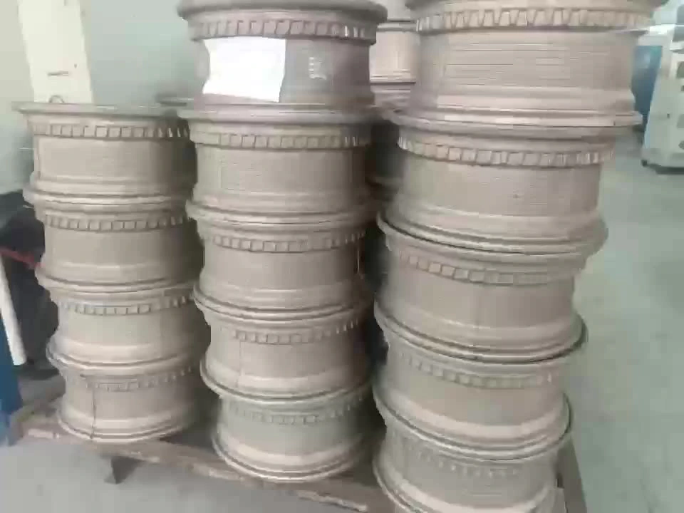 Stacked ceramic molds for decorative pots, showcasing intricate designs and craftsmanship in a workshop setting.