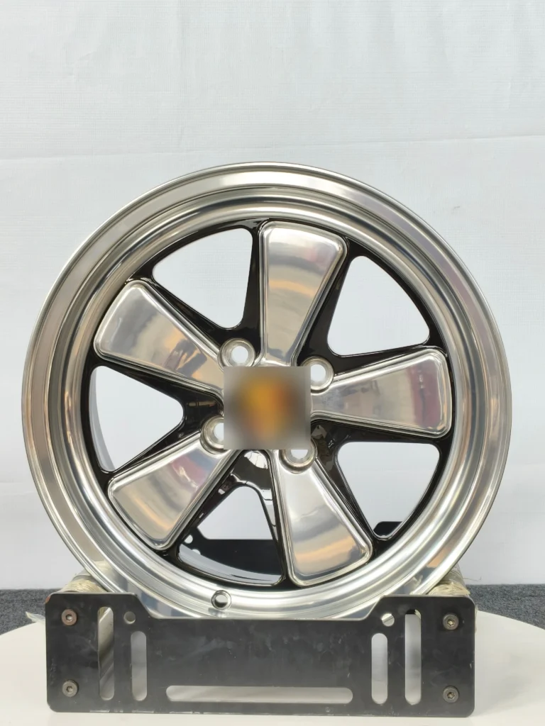 Stylish chrome and black alloy wheel displayed on a stand, ideal for enhancing vehicle performance and aesthetics.